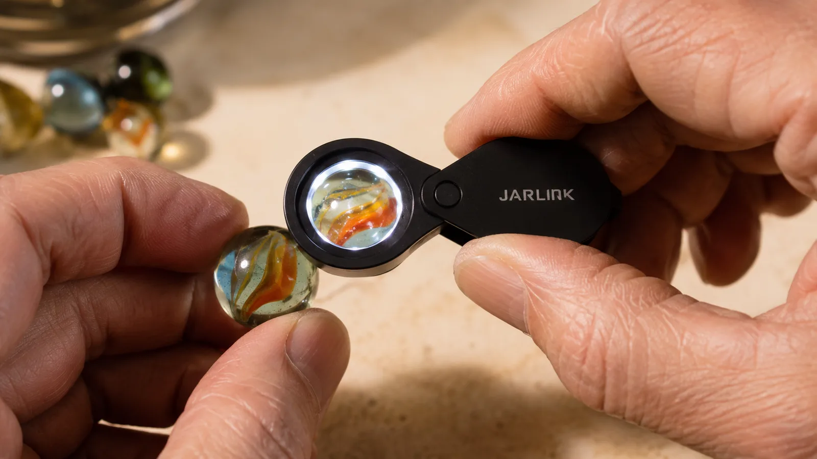 A close shot of a jeweler's loupe pressed close to a marble, its ring of LED light showing the fine inner swirl and a tiny chip at the surface